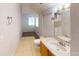 Bright bathroom featuring a modern vanity, a large mirror, and tile flooring at 5132 Luna Negra Dr, Orlando, FL 32811