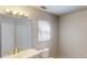 Bright bathroom with a window and a vanity featuring ample lighting at 5132 Luna Negra Dr, Orlando, FL 32811