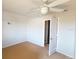 Bright bedroom showcasing a door, a ceiling fan, and a carpeted floor at 5132 Luna Negra Dr, Orlando, FL 32811