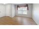 Bright living room featuring wood floors, a large window, and fresh paint at 5132 Luna Negra Dr, Orlando, FL 32811