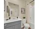 Well-lit bathroom featuring a gray vanity, framed mirror, and a shower-tub combination with a curtain at 5233 Marshelder St, Apopka, FL 32712