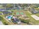 Aerial view of community amenities including tennis courts, a playground, a pool, and a clubhouse at 527 Durango Loop St, Davenport, FL 33897