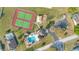 Aerial view of community amenities including tennis courts, a playground, a pool, and a parking lot at 527 Durango Loop St, Davenport, FL 33897