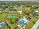 Community aerial view showcasing the pool, tennis courts, playground, and lush greenery at 527 Durango Loop St, Davenport, FL 33897