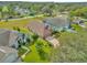 Aerial view of the home featuring a well maintained lawn, landscaping, and private drive at 527 Durango Loop St, Davenport, FL 33897