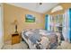 Bright bedroom featuring a large window, blue curtains, and a cozy patchwork quilt at 527 Durango Loop St, Davenport, FL 33897