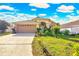 Inviting single-Gathering home featuring a well-manicured lawn and a two-car garage at 527 Durango Loop St, Davenport, FL 33897