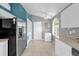 Well-lit kitchen featuring stainless steel appliances, white cabinets, and tile flooring at 527 Durango Loop St, Davenport, FL 33897