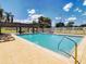 Relaxing community pool area with comfortable lounge chairs and a covered pergola at 527 Durango Loop St, Davenport, FL 33897