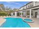 Beautiful backyard featuring a luxurious pool, spa, and covered patio with columns at 6030 Greatwater Dr, Windermere, FL 34786