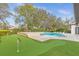 Beautiful backyard featuring a custom pool, putting green, and ample lounge space at 6030 Greatwater Dr, Windermere, FL 34786