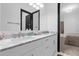 Bathroom featuring dual sinks, a white marble counter, and gray accents at 6030 Greatwater Dr, Windermere, FL 34786