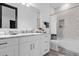 This bathroom features white cabinets, marble countertops, and modern finishes at 6030 Greatwater Dr, Windermere, FL 34786