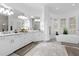 Bright bathroom featuring marble countertops, dual sinks, soaking tub, and a shower at 6030 Greatwater Dr, Windermere, FL 34786