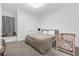 Neutral bedroom featuring a gray bed frame, window bench, and a wooden crib at 6030 Greatwater Dr, Windermere, FL 34786