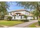 Beautiful two-story home with a brick driveway, manicured landscaping, and neutral paint at 6030 Greatwater Dr, Windermere, FL 34786