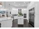 Open kitchen featuring white cabinetry, stainless steel appliances, and dark wood flooring at 6030 Greatwater Dr, Windermere, FL 34786