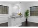 Stylish wet bar featuring marble countertops, white cabinets and modern fixtures at 6030 Greatwater Dr, Windermere, FL 34786