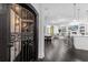 Wine cellar in open concept main living area with dark wood floors and white walls at 6030 Greatwater Dr, Windermere, FL 34786