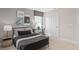 Stylish bedroom featuring a black metal bed frame, neutral decor, and ample natural light at 6799 Willow View Ave, Orlando, FL 32829