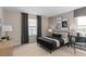 Well-lit bedroom showcasing a modern black bed frame, dresser, and dark curtains over a bright window at 6799 Willow View Ave, Orlando, FL 32829