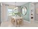 Dining room featuring natural light, elegant chandelier, decorative mirror, and access to bedroom at 6799 Willow View Ave, Orlando, FL 32829