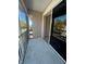 A balcony with a sliding glass door, aluminum railings, and view of green trees at 7109 Yacht Basin Ave # 430, Orlando, FL 32835