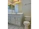 Bathroom featuring a white vanity with a sink, a mirror, a toilet, and modern lighting at 7109 Yacht Basin Ave # 430, Orlando, FL 32835