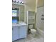 Well-lit bathroom featuring a vanity, toilet with storage, and a tiled shower-tub combination at 7109 Yacht Basin Ave # 430, Orlando, FL 32835