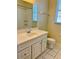 Bright bathroom showcasing a white vanity with a sink, a mirror, and a toilet with modern fixtures at 7109 Yacht Basin Ave # 430, Orlando, FL 32835