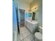 Bathroom with a white vanity, mirror, lighting, a toilet and access to a shower and bedroom at 7109 Yacht Basin Ave # 430, Orlando, FL 32835