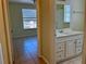 Bathroom featuring a white vanity with a sink, a mirror, and an open view to an adjacent bedroom at 7109 Yacht Basin Ave # 430, Orlando, FL 32835