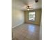 A naturally lit empty bedroom features tile flooring, a ceiling fan, and a window at 7109 Yacht Basin Ave # 430, Orlando, FL 32835