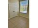 A bright bedroom with tiled flooring, a double closet and natural light streaming through the window at 7109 Yacht Basin Ave # 430, Orlando, FL 32835