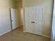 A cozy bedroom featuring neutral walls, a double closet and natural light from the window at 7109 Yacht Basin Ave # 430, Orlando, FL 32835