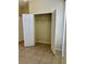 A bright closet featuring tiled flooring and a rod for hanging clothes at 7109 Yacht Basin Ave # 430, Orlando, FL 32835