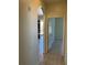 Hallway with neutral paint, tile flooring, and an archway leading to a living space at 7109 Yacht Basin Ave # 430, Orlando, FL 32835