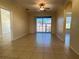 Bright living room showcasing tile flooring and a balcony with outside views at 7109 Yacht Basin Ave # 430, Orlando, FL 32835