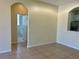 Open-concept living area with arched openings to kitchen and bathroom at 7109 Yacht Basin Ave # 430, Orlando, FL 32835