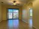 A well-lit living room featuring tile floors, a ceiling fan, and a sliding glass door to a balcony at 7109 Yacht Basin Ave # 430, Orlando, FL 32835