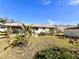 Large backyard featuring tropical plants, landscaping, and view of the screened-in porch at 716 Caribou Dr, Kissimmee, FL 34759