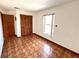 Bedroom featuring wood-look flooring, a window, and a closet at 716 Caribou Dr, Kissimmee, FL 34759