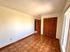 Bedroom featuring wood-look flooring, a window, and a closet at 716 Caribou Dr, Kissimmee, FL 34759