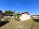 Exterior of home showcasing a well-maintained yard and glimpses of the sunroom at 716 Caribou Dr, Kissimmee, FL 34759