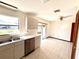 Bright kitchen and dining area with stainless steel dishwasher and a window overlooking the yard at 716 Caribou Dr, Kissimmee, FL 34759