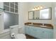 Bathroom featuring a double sink vanity with granite countertop, large mirror, and tiled floors at 719 S Summerlin Ave, Orlando, FL 32801