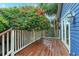 Wood deck with railings, outdoor lighting, and lush landscaping at 719 S Summerlin Ave, Orlando, FL 32801