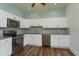 Modern kitchen featuring white cabinets, granite countertops, and stainless steel appliances at 719 S Summerlin Ave, Orlando, FL 32801