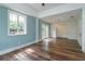 Bright living room with light blue walls, hardwood floors, large window, and glass doors to the exterior at 719 S Summerlin Ave, Orlando, FL 32801