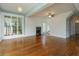 Open-concept living room with hardwood floors, fireplace, and staircase at 719 S Summerlin Ave, Orlando, FL 32801